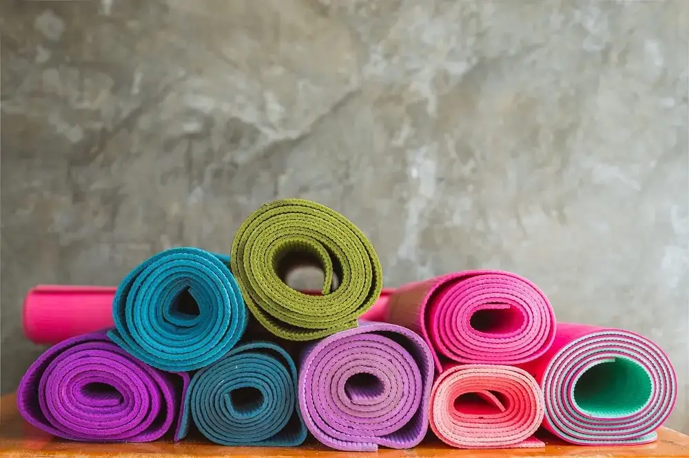 Neatly arranged yoga mats and props.